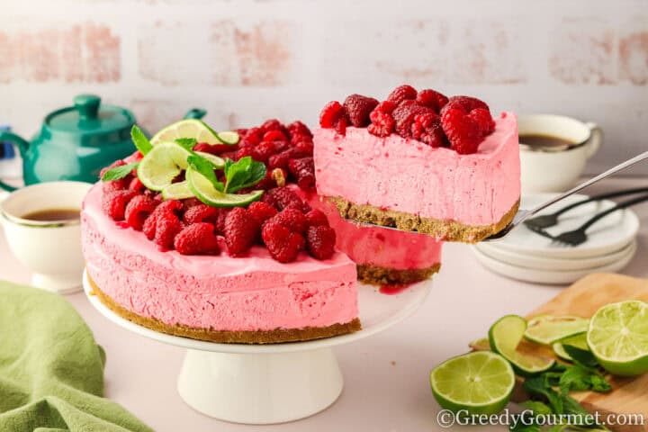 Raspberry cheesecake on a cake stand.