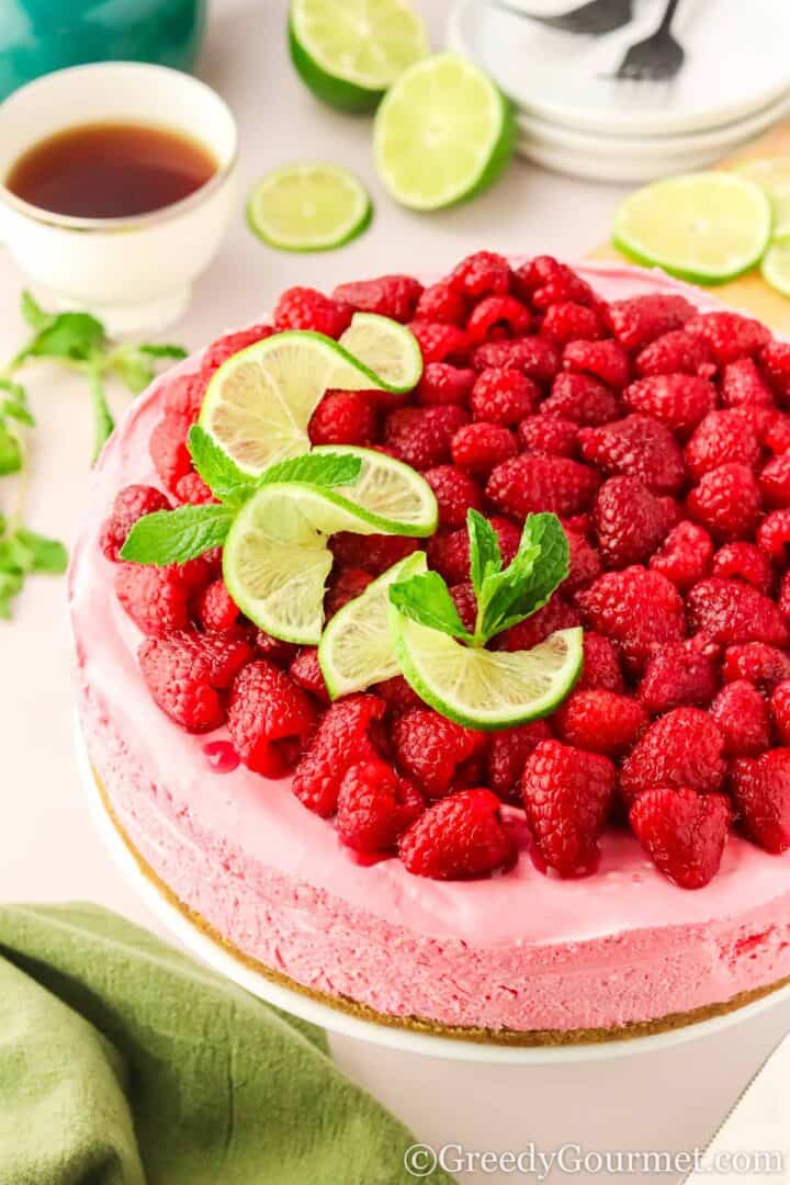 Raspberry cheesecake on a cake stand.
