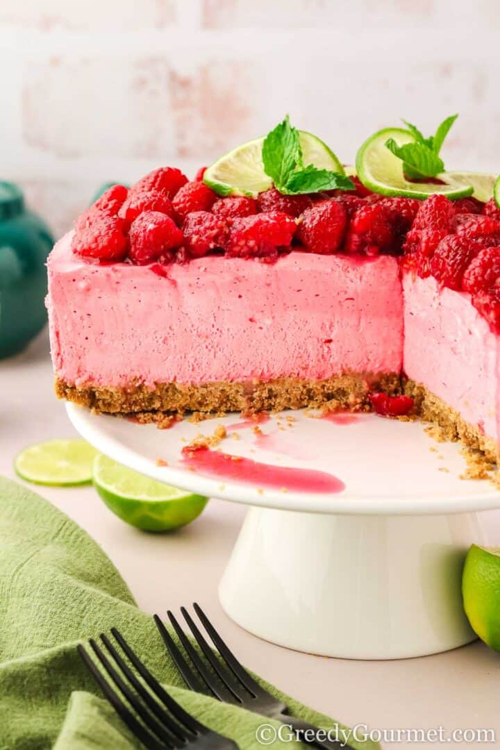 Closeup of Raspberry cheesecake on a cake stand.