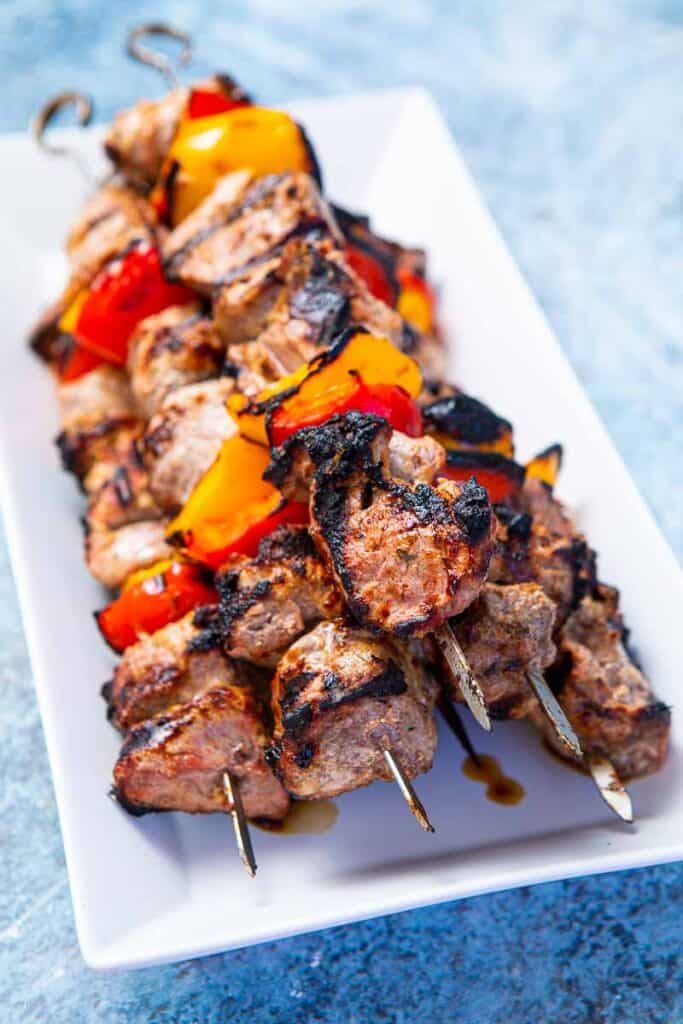 Grilling Marinated Shashlik On A Grill. Shashlik Is A Form Of Shish Kebab  Popular In Eastern, Central Europe And Other Places. Shashlyk (meaning  Skewered Meat) Was Originally Made Of Lamb. Stock Photo