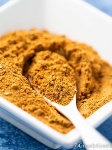Close up of a spoonful of old bay seasoning.